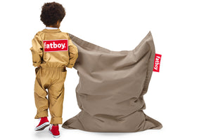 Boy Standing Next to a Taupe Fatboy Junior Stonewashed Bean Bag Chair
