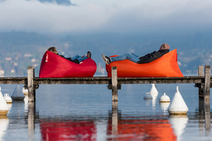 People Laying in Fatboy Lamzac Loungers on a Boat Dock