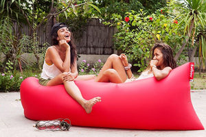Two Girls Laying in a Red Fatboy Lamzac the Original