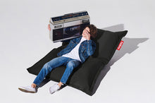 Load image into Gallery viewer, Guy Laying on a Thunder Grey Fatboy Original Outdoor Bean Bag
