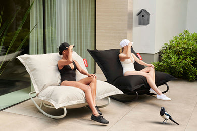 Girls Sitting on Fatboy Original Outdoor Bean Bag Rockers on a Patio