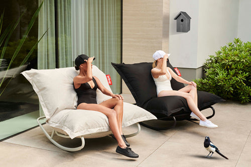 Girls Sitting on Fatboy Original Outdoor Bean Bag Rockers on a Patio