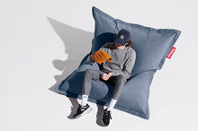 Load image into Gallery viewer, Guy Sitting on a Blue Fatboy Original Stonewashed Bean Bag
