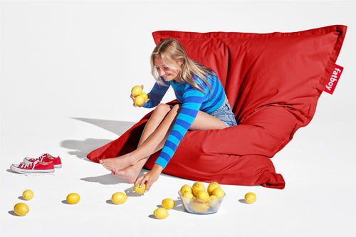 Girl Sitting on a Red Fatboy Original Stonewashed Bean Bag