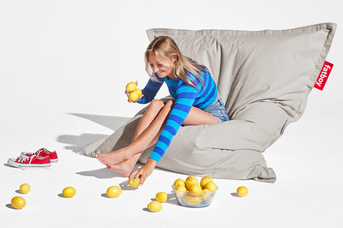 Girl Sitting on a Silver Grey Fatboy Original Stonewashed Bean Bag