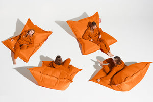 Girl Sitting on an Orange Bitters Fatboy Original Bean Bag in Different Positions