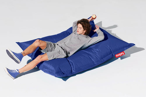 Guy Laying on a Petrol Fatboy Original Slim Bean Bag Chair