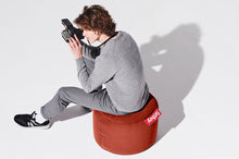 Load image into Gallery viewer, Guy Sitting on a Rhubarb Fatboy Point Stonewashed Pouf
