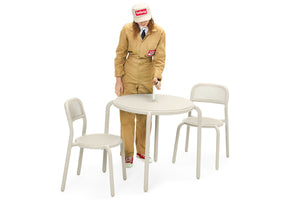 Model Standing Next to a Desert Fatboy Toni Bistreau with Toni Chairs