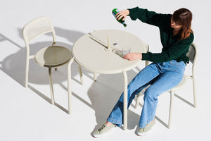 Model Sitting at a Desert Fatboy Toni Bistreau with Toni Chairs Pouring a Drink