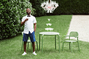 Model Standing Next to a Mist Green Fatboy Toni Bistreau and Chairs on the Lawn